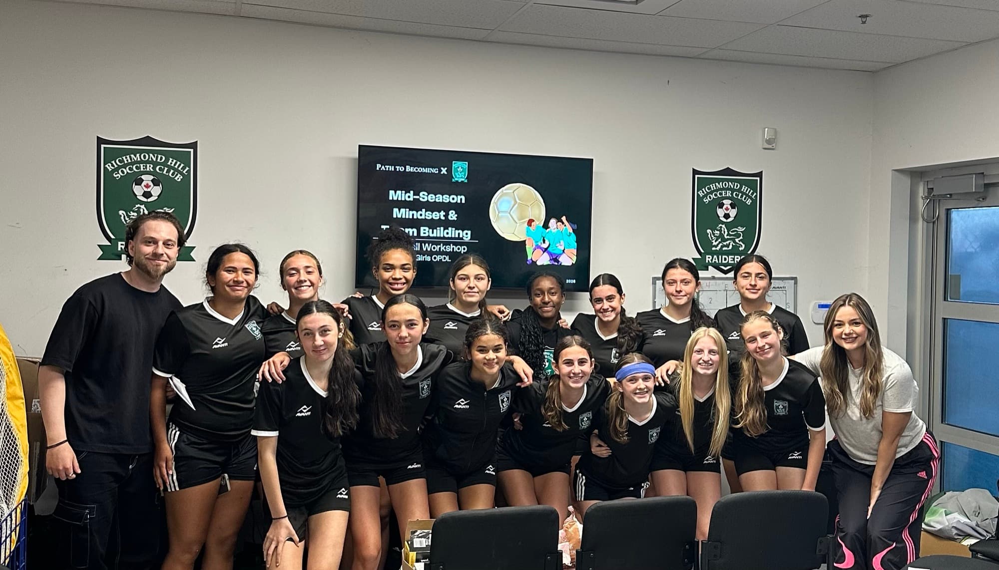Michael and Amalia with a soccer team after a Path to Becoming mid-season mindset and team-building workshop